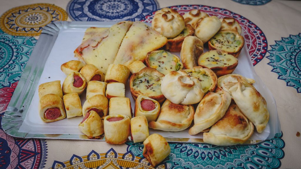 Picnic lunch with mini empanadas and other bite-sized snacks.