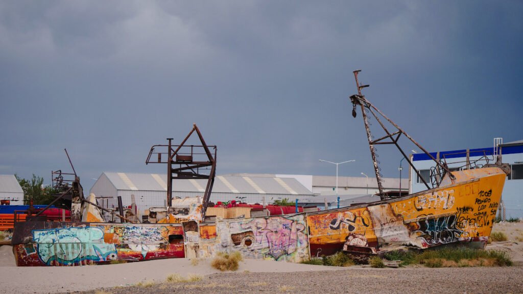 Old boats covered in graffiti on Playa Costanera in Comodoro Rivadavia 