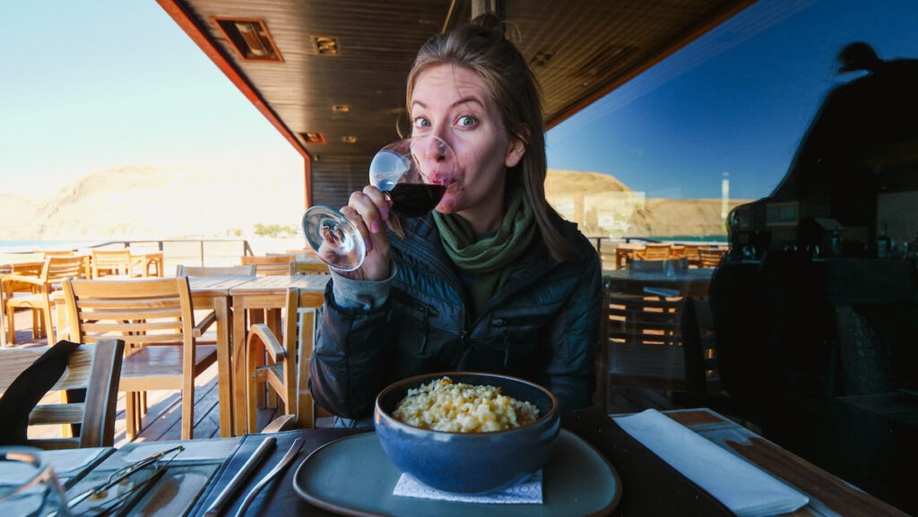 Audrey eating seafood risotto at a beach restaurant in Rada Tilly, Chubut 
