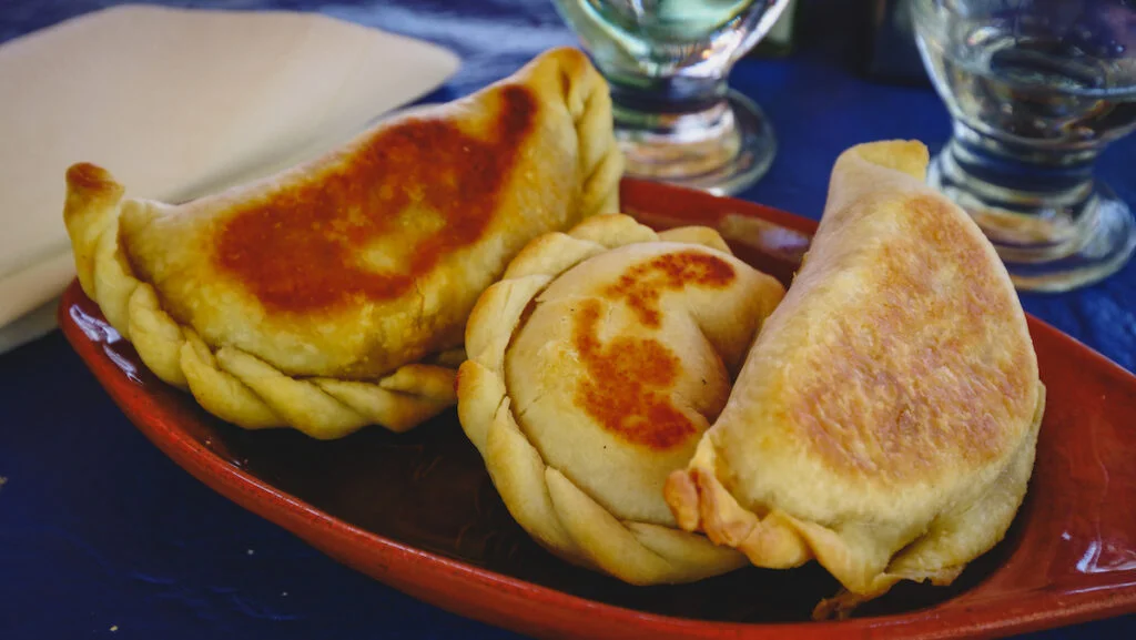 Eating empanadas tucumanas in Amaicha del Valle Eating empanadas tucumanas in Amaicha del Valle