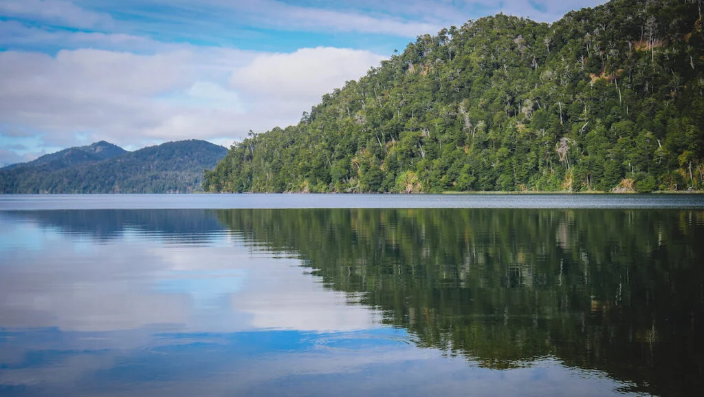 The waters of Lake Correntoso were almost mirror-like. The waters of Lake Correntoso were almost mirror-like.