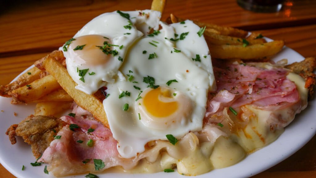 Milanesa al caballo is an Argentine dish consisting of breaded veal cutlet with ham, cheese, and two fried eggs on top.