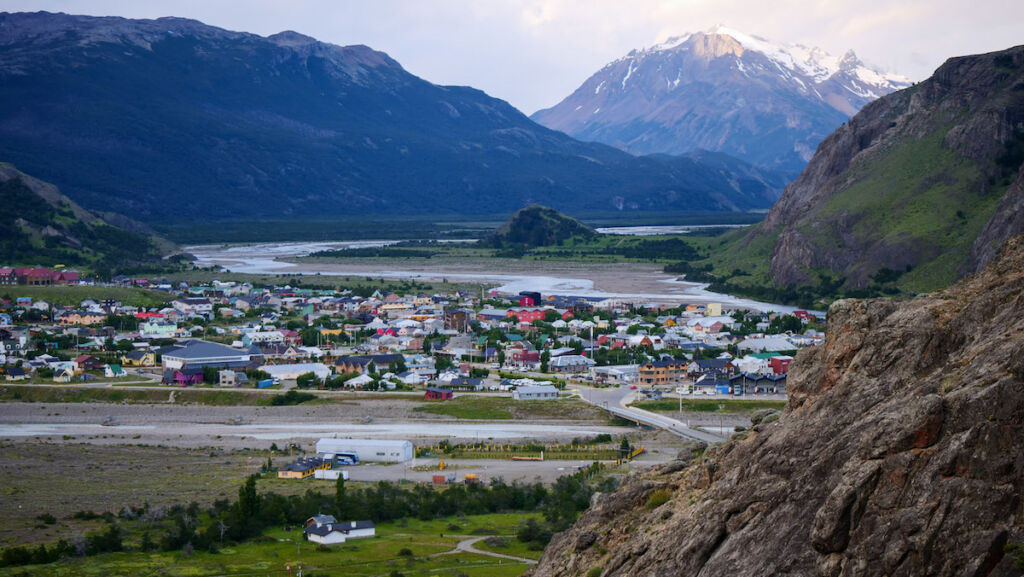 Views of the town of El Chalten with mountains in the horizon and the Las Vueltas River flowing to the east of town.