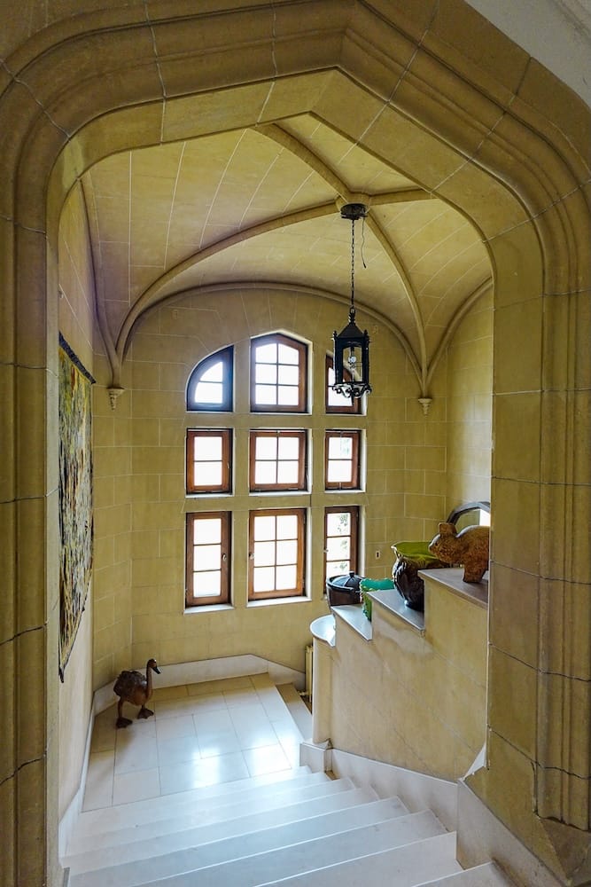 Marble staircase with stone arches are part of the Norman Tudor style architecture at Estancia Villa Maria.