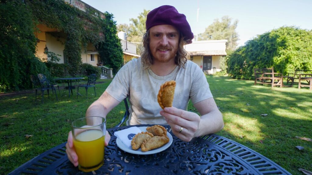 Eating fried empanadas at Estancia El Ombu de Areco 