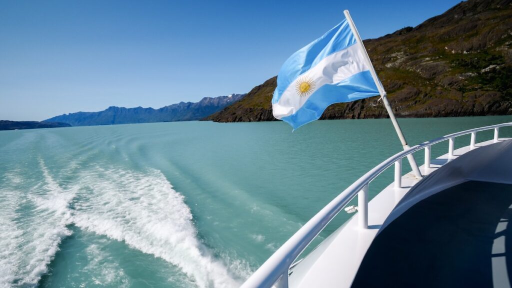 Argentine flag flapping in the wind aboard our El Calafate glacier boat tour 