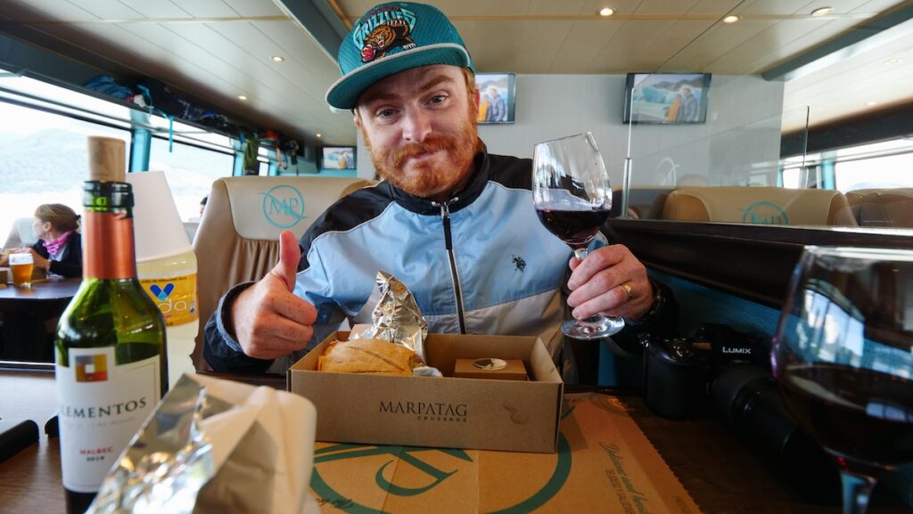 Eating our Gourmet Glaciers lunchbox featuring a Patagonian lamb sandwich aboard the Maria Turquesa glacier boat tour 