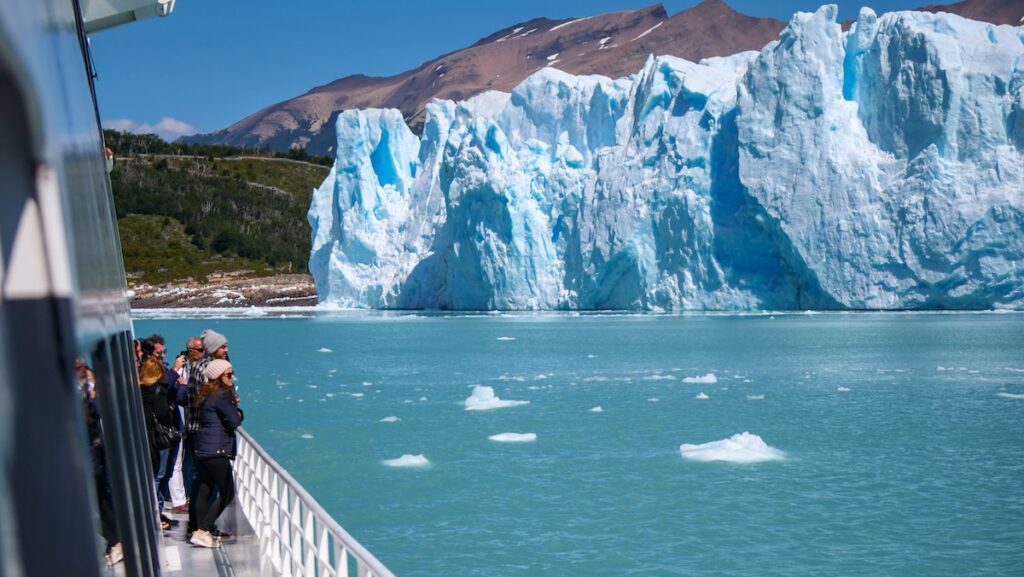 Passengers enjoying views of Perito Moreno Glacier boat cruise in Los Glaciares National Park 