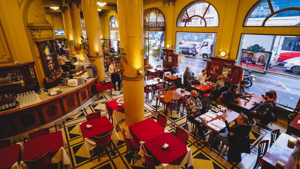Las Violetas in Buenos Aires is a historic cafe with large stained glass windows and beautiful architectural details.