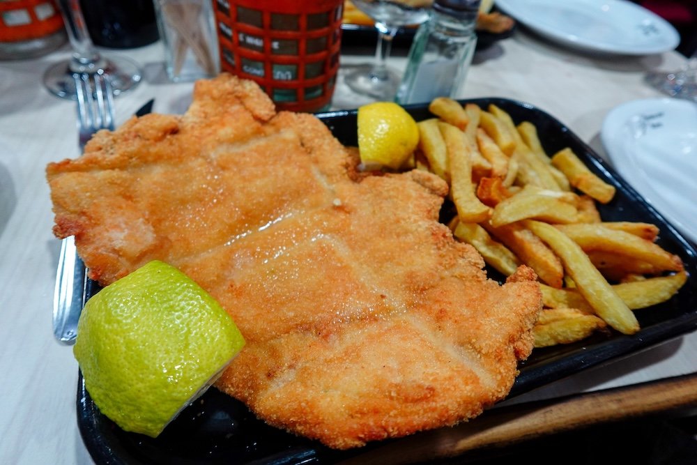 Suprema de pollo is a chicken milanesa made from breast lightly breaded and fried until golden.