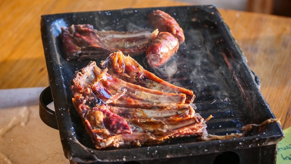 Patagonian lamb ribs on the barbecue.