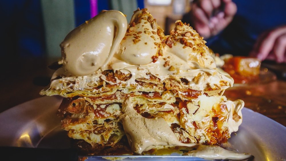 This Rogel cake has layers of dulce de leche and a meringue and dulce de leche coating.