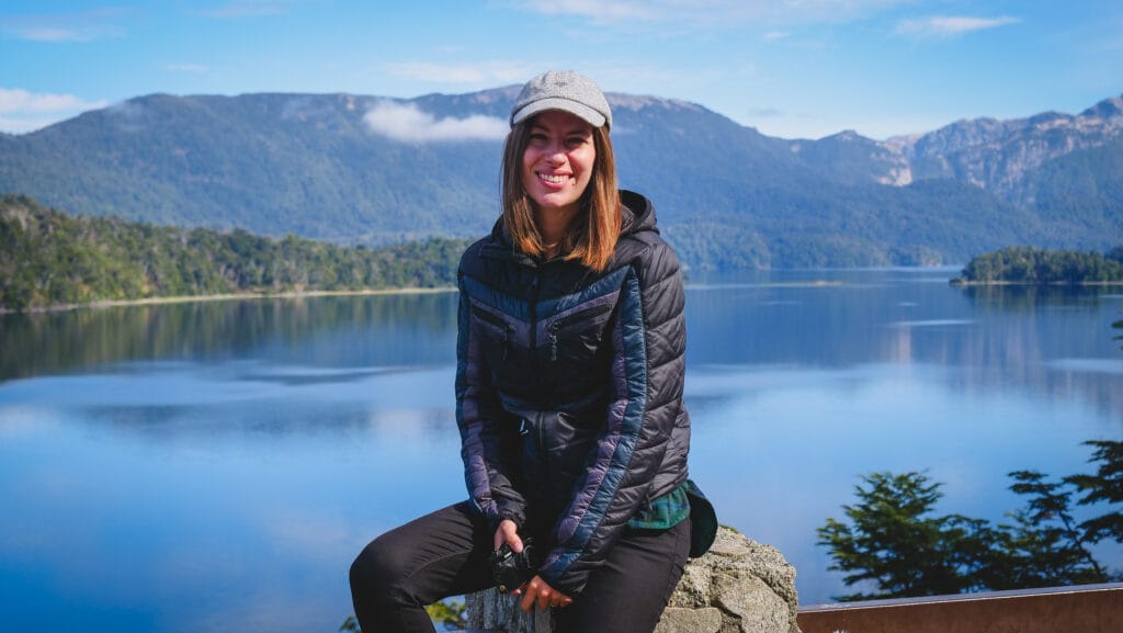 Audrey Bergner, founder of Che Argentina Travel, resting on a rustic bench at a traditional estancia along the Ruta de los Siete Lagos (Seven Lakes Route) in Patagonia during a field research trip.