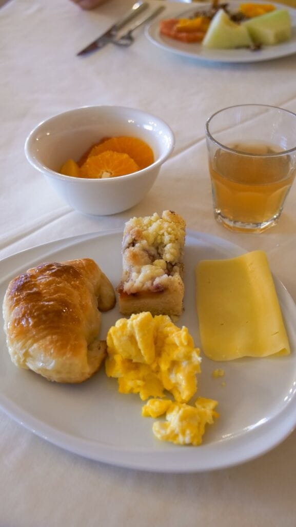 Breakfast spread with medialuna, pastries, fruit and cheese