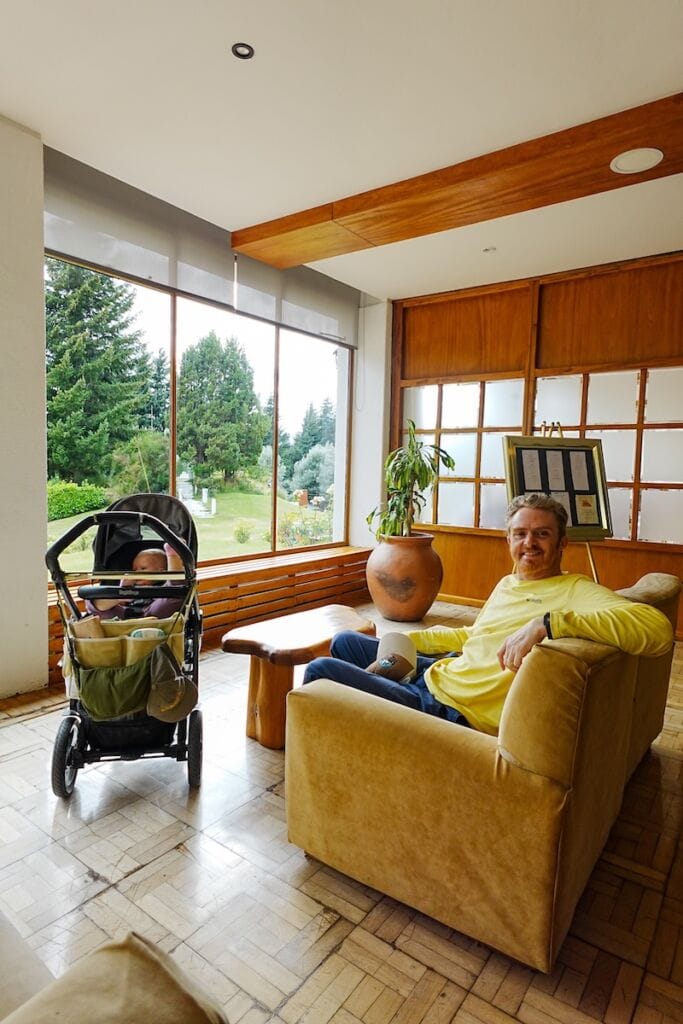 Samuel sitting in the lobby at Gran Hotel Panamericano enjoying the lake views