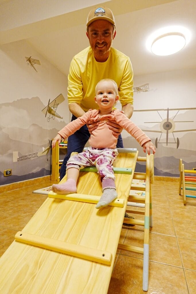 Samuel and Aurelia playing on a climbing board in the Kids Playroom at the hotel