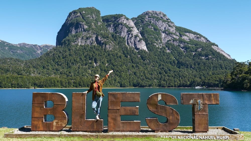 Audrey posing in front of the BLEST sign next to the port.