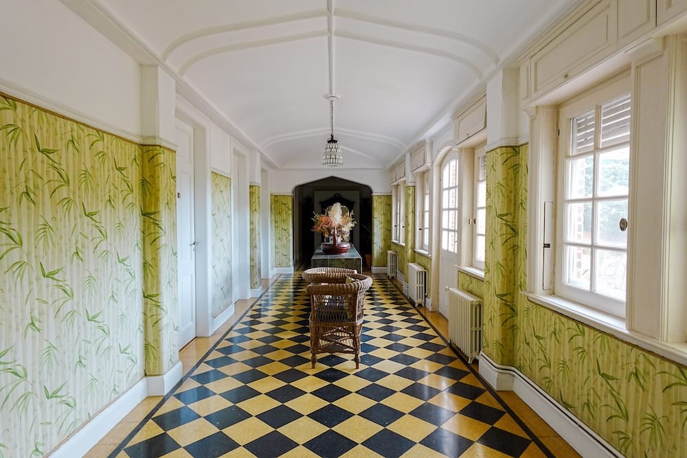 One of the hallways at the estancia with a white and black checkered floor tile.
