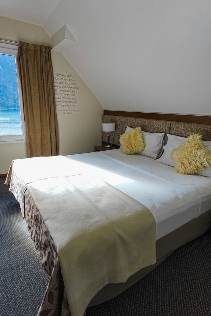 Standard room with a queen size bed and lake views at Hotel Puerto Blest, Patagonia.