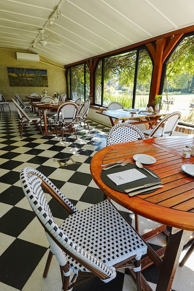 The sunroom set up for lunch at the estancia where guests can enjoy the garden views.