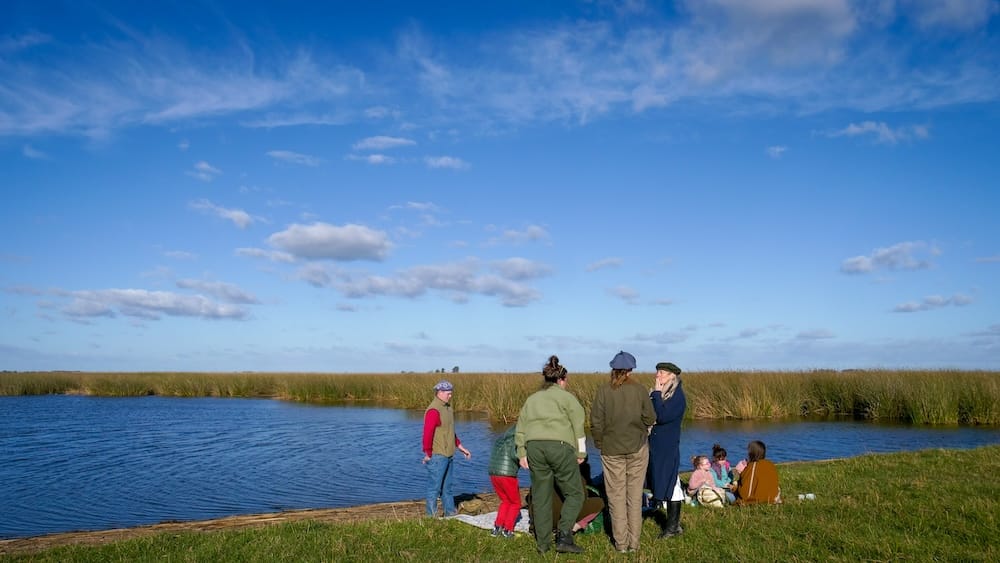 Guests gather next to the lagoon for merienda or tea time at Estancia La Tomasa.
