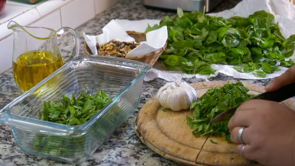 Basil being processed in the kitchen for a future meal at the estancia.