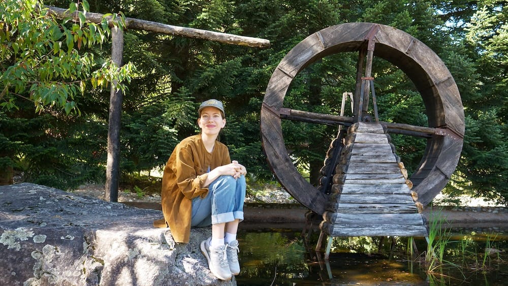 Audrey posing next to a waterwheel, one of the many attractions in Peulla, Chile.