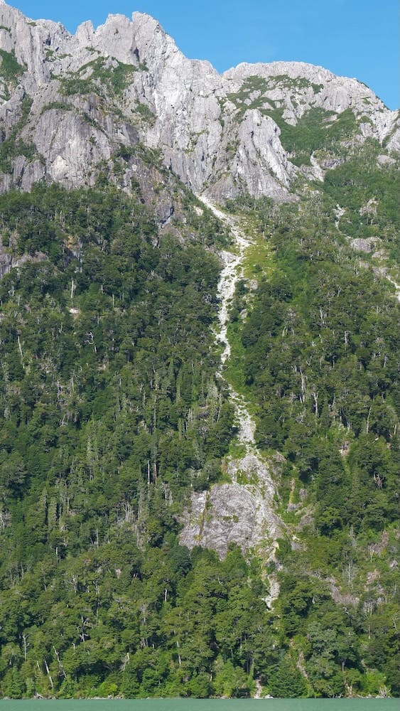 A waterfall cascading down the mountain on the boat ride across Lago Frias.
