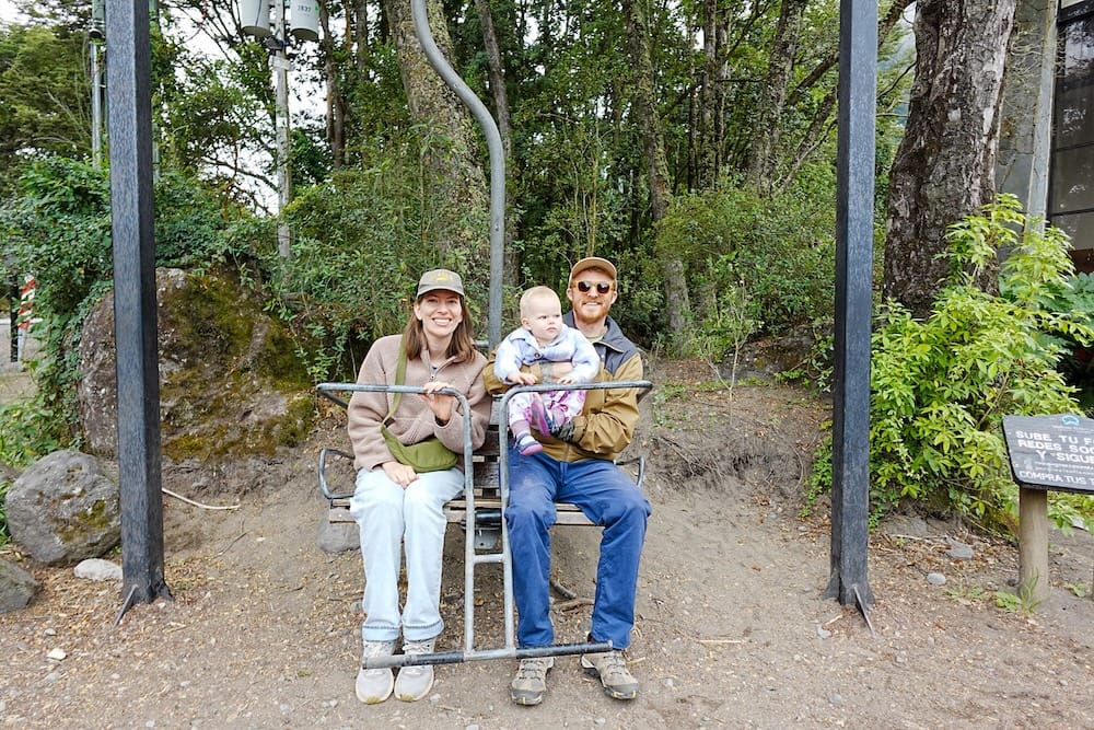 Samuel, Audrey and Aurelia sitting at the entrance to Petrohué Falls in Chile.