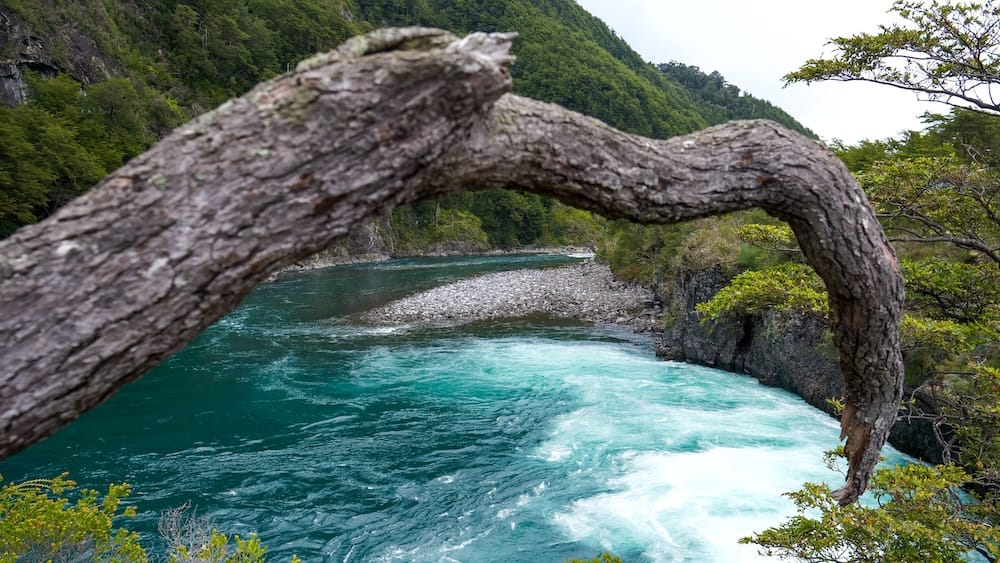 The turquoise waters of the Petrohué River flow over basaltic lava at Petrohué Falls in Chile. 
