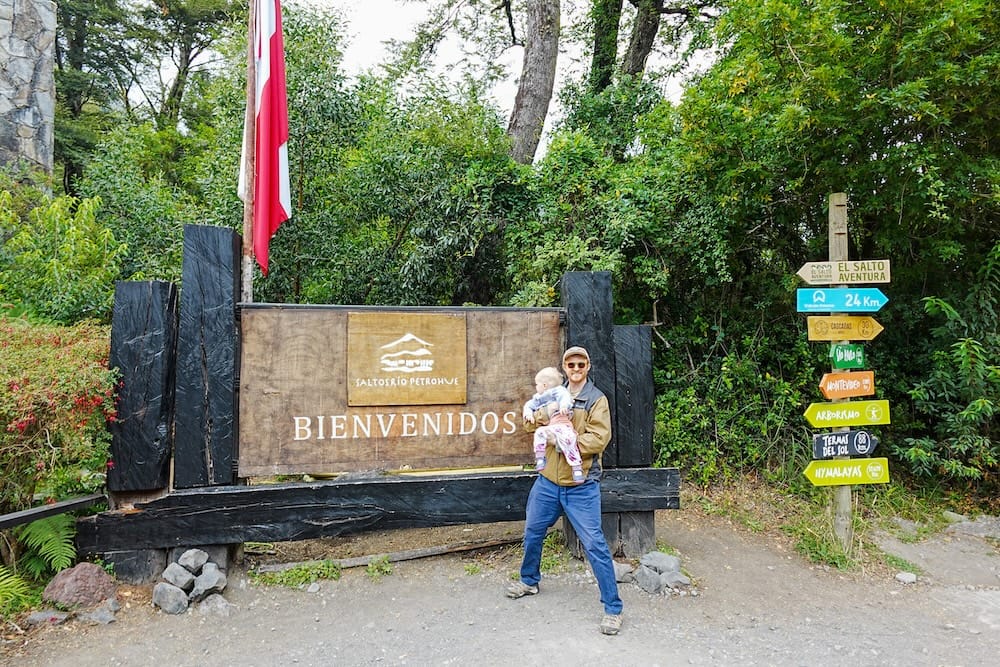Samuel and Aurelia standing at the entrance of Saltos del Petrohué in Chile during the return trip of the Cruce Andino.